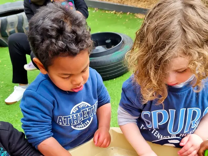 Children playing on sustainable wooden playground equipment at Little Stars